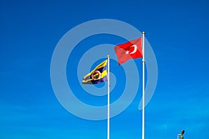 Flags of Fenerbahce SK and Turkey against the blue sky photo