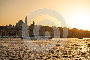 Istanbul, Turkey. The Golden Horn at sunset. Suleymaniye mosque silhouette.