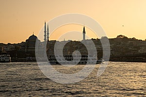 Istanbul, Turkey. The Golden Horn at sunset. Yeni Cami mosque silhouette.