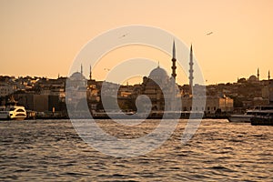 Istanbul, Turkey. The Golden Horn at sunset. Yeni Cami mosque silhouette.