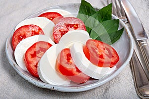 Itaian vegetarian food, fresh caprese salad made with white soft italian mozzarella cheese, red tomato and green basil with olive