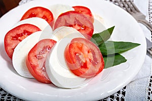 Itaian vegetarian food, fresh caprese salad made with white soft italian mozzarella cheese, red tomato and green basil with olive