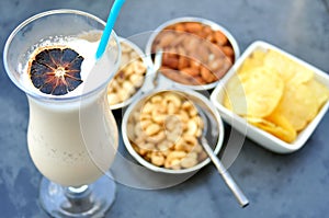 Italian alcohoolic cocktail with snack on a table in a restaurant