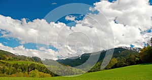 Italian Alps, Dolomiti. Moving clouds at the day light. Timelapse and view to valley and field.