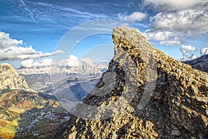 Autumn view on the mountain cliff in the italian alps with blue cloudy sky photo