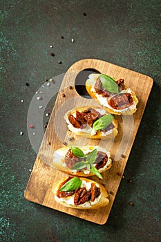 Italian Antipasti snacks for Wine. Brushetta with Soft Cheese and Dried Tomatoes