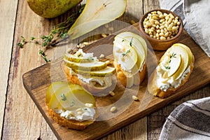 Italian Antipasti snacks for Wine. Brushetta with Soft Cheese, Pear and Pine Nuts