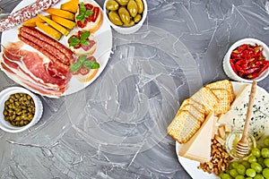 Italian antipasti wine snacks set. Antipasto catering platter with jerky, salami, cheese , grapes, olives, pickles, Prosciutto di