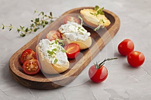 Italian appetizer toasted bread bruschetta with cream chease and tomatoes photo