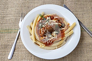 Italian braciole served with bucatini pasta