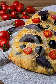 Italian bread focaccia with olive, basil and cherry tomato