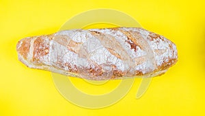 Italian bread on yellow background. Top view