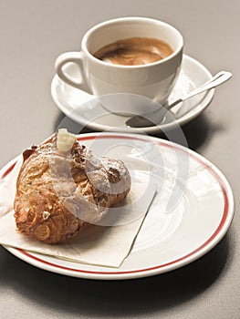 Italian breakfast with croissant and cafe macchiato at coffee shop photo