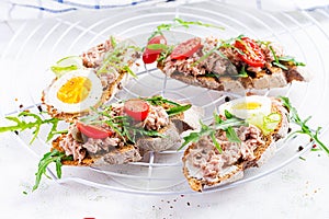 Italian bruschetta sandwiches with canned tuna, tomatoes and capers.