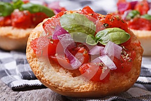 Italian bruschetta with tomato, onion and basil close-up