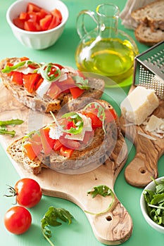 Italian bruschetta with tomatoes parmesan arugula