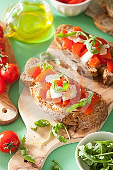 Italian bruschetta with tomatoes parmesan rucola