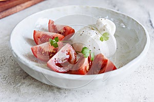 Italian burrata cheese with tomatoes and olive oil