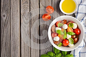 Italian Caprese salad with cherry tomatoes, small mozzarella and fresh basil