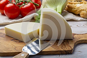 Italian cheese, Provolone dolce cow cheese from Cremona served with olive bread and tomatoes