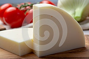 Italian cheese, Provolone dolce cow cheese from Cremona served with olive bread and tomatoes