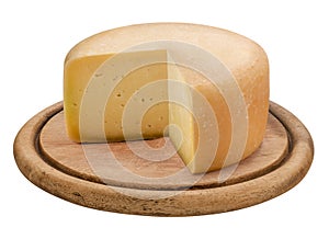 Italian cheese, Tuscan caciotta on a round wooden cutting board, isolated on white background