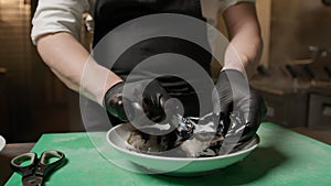 Italian Chef Hands Are Cleaning A Squid To Obtain Black Ink Juice