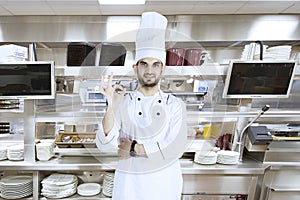 Italian chef showing OK sign in the kitchen