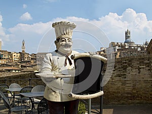 Italian chef with the Siena panoramic view on his