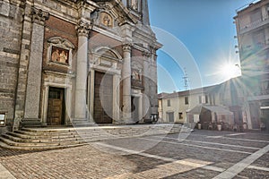 Italian church and shining sun in the blue sky