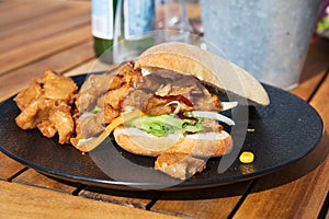 Italian ciabata bread served with fresh salade and vegan fried chicken in pieces