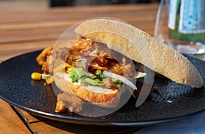 Italian ciabata bread served with fresh salade and vegan fried chicken in pieces