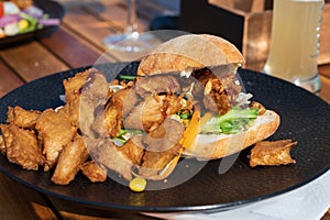 Italian ciabata bread served with fresh salade and vegan fried chicken in pieces