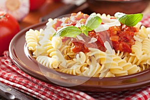 Italian classic pasta fusilli with tomato sauce and basil