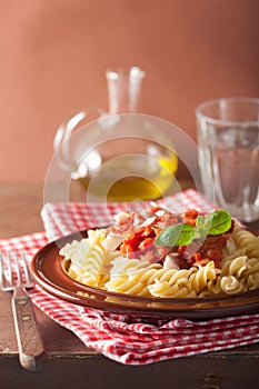 Italian classic pasta fusilli with tomato sauce and basil