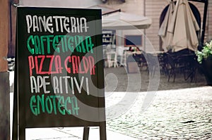 Italian coffe bar signboard with the words panetteria bakery, caffetteriacafeteria, pizza calda hot pizza, aperitivi