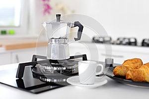 Italian coffee maker and croissants