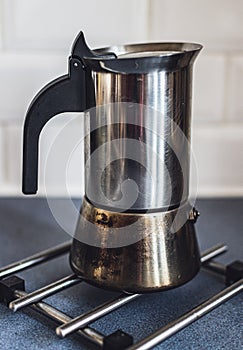 Italian coffee maker on a kitchen counter top.