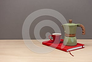Italian coffee maker small cup and red notebook