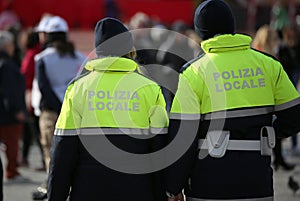 italian cops with uniform with the text POLIZIA LOCALE which mea