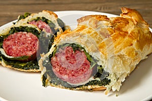 Italian cotechino in crust with spinach