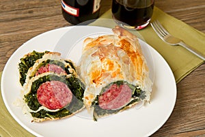 Italian cotechino in crust with spinach