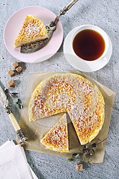 Italian cuisine. Orange and ricotta cottage cheese grated tart and tea cup