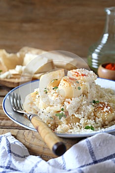 Italian cuisine. Plate of scallop risotto, olive oil and parmesan cheese