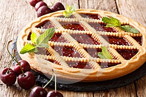 Italian dessert cherry pie tarts Crostata close-up on the table. photo