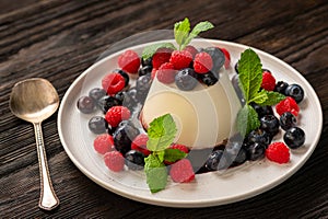 Italian dessert - panna cotta with berries and caramel sauce