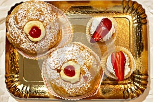 Italian dessert Zeppole di San Giuseppe, zeppola baked puffs made from choux pastry, filled and decorated with custard photo