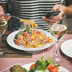 Italian dinner at bistrot with caprese salad and pasta photo