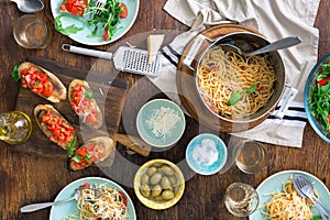 Italian dinner table with pasta, appetizers and white wine