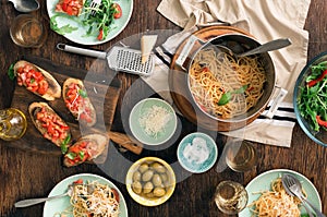 Italian dinner table with pasta, bruschetta and salad